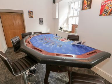 A poker room with a poker table and chairs by a window at Bryn Derwen Bethesda near Caernarfon