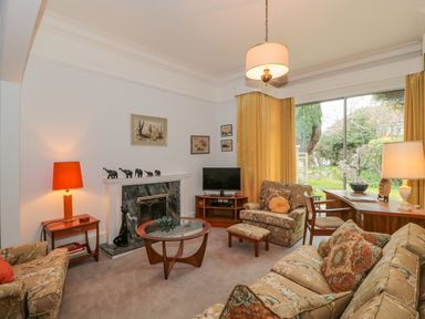 A living room with armchairs sofa coffee table and lamps at West Ridge in Boscombe