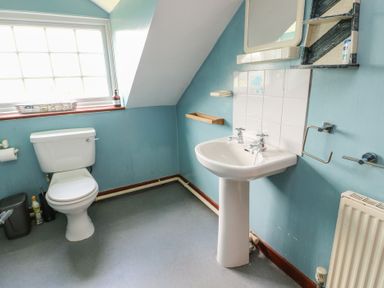 A bathroom with a toilet and sink at Glan y Gors in Dinorwic near Llanberis