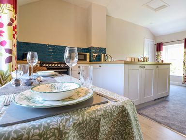 A kitchen with a table set for dining at Peniarth in Penybontfawr near Oswestry