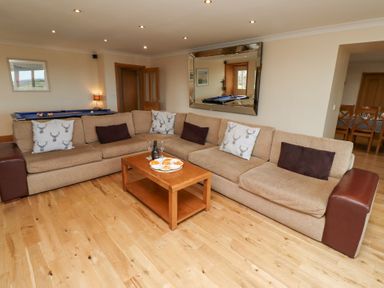 A living room with a sofa and coffee table at Granary Stone House in Embleton