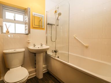 A bathroom with a toilet sink bathtub and a window at Pear Tree Cottage in Mark near Burnham-on-Sea