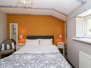 A bedroom with a bed and bedside tables at Pear Tree Cottage Mark near Burnham-on-Sea