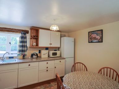 A kitchen with a table and chairs at West Bowden Farm Knowstone near South Molton