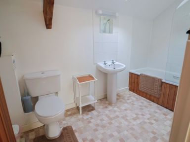 A bathroom with a toilet, sink, and bathtub at West Bowden Farm in Knowstone near South Molton