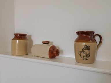 A shelf with three ceramic containers at West Bowden Farm Knowstone near South Molton
