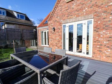 An outdoor dining area with a table and chairs at Heather Croft in Robin Hood's Bay
