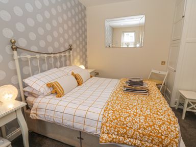 A bedroom with a bed and bedside tables at The Store Rooms in Whitby