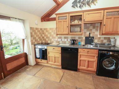 A kitchen with appliances and cabinetry at Sonya's Cottage Anthorn, Solway Firth