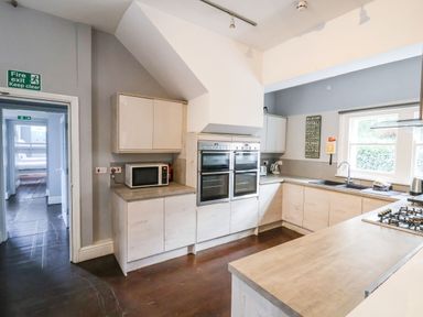 A kitchen with ovens microwave a sink and a gas stove at Mountain View in Penmaenmawr