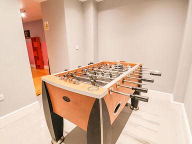 A foosball table in a room with light gray walls and light floor at Mountain View in Penmaenmawr