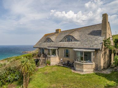 A house with a garden and deck overlooking the sea at Cragford Sennen Cove
