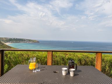 A table with drinks overlooking the sea at Cragford Sennen Cove