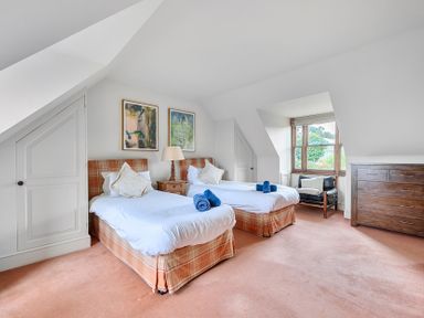 A bedroom with two beds and a dresser at Cragford in Sennen Cove