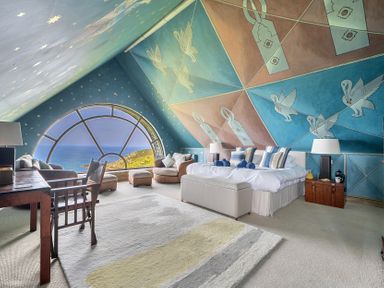 A bedroom with a large window and sea view at Cragford in Sennen Cove
