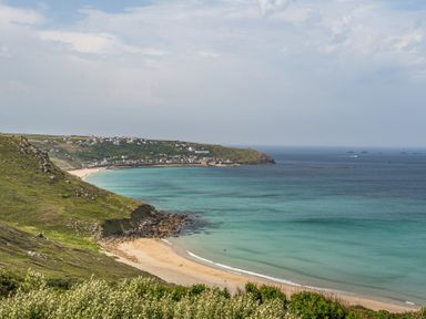 A beach with sand and water at Cragford in Sennen Cove