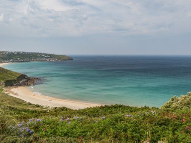 A beach with ocean and hills at Cragford in Sennen Cove