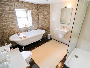 A bathroom with a freestanding bathtub and shower at Whispering Willows - The Thatch in Carndonagh County Donegal