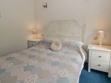 A bedroom with a bed and bedside tables at Teifi House near Cilgerran Cardigan
