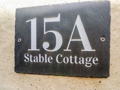 A house number plaque with 15A Stable Cottage on a wall at Stable Cottage in Pembroke