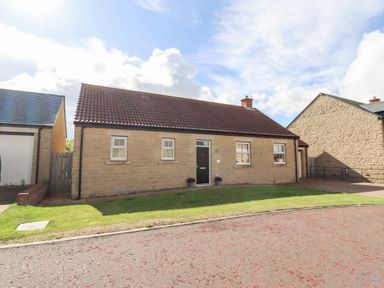 A house with a garden and pathway at The Haven in Embleton