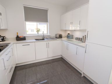 A kitchen with a sink and appliances at The Haven in Embleton