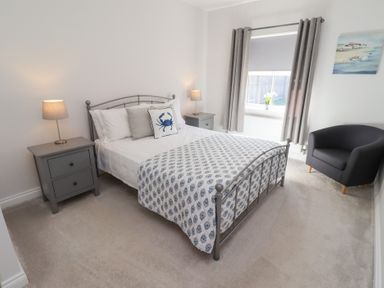A bedroom with a bed and nightstand at The Haven in Embleton