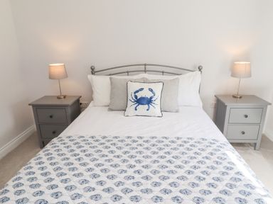A bedroom with a bed and bedside tables at The Haven in Embleton