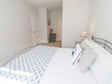 A bedroom with a bed and a chair at The Haven in Embleton