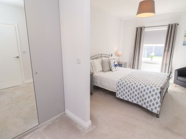 A bedroom with a bed and nightstand at The Haven in Embleton