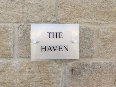 Sign for The Haven at Embleton on a stone wall