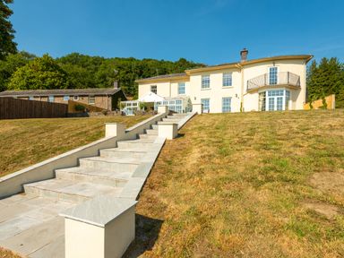 A house with multiple windows and a balcony with stairs leading up to it at Old Rectory House in Caersws