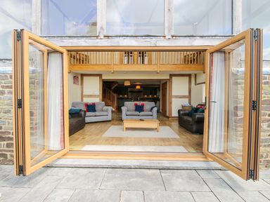 A living room with sofas and a coffee table at The Hayloft Bleddfa near Knighton