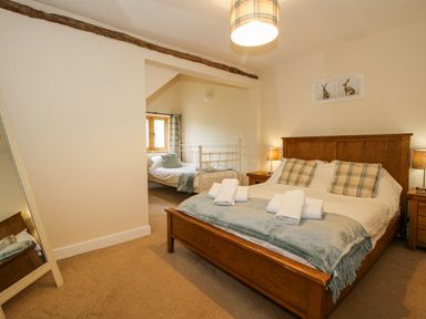 A bedroom with a bed and a window at The Hayloft in Bleddfa near Knighton