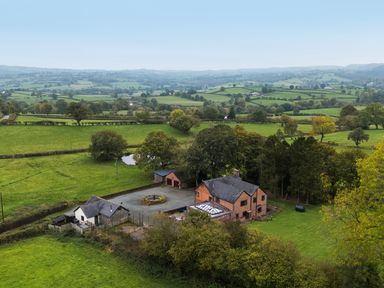 An aerial view of a house with garden and garage at Ty Newydd in Llangadfan