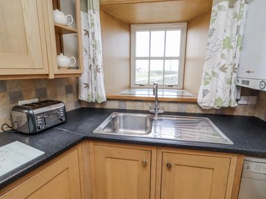 A kitchen with a sink and toaster at High Hemmel House in Embleton