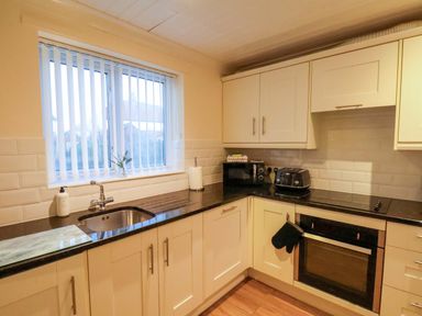 A kitchen with counter and appliances at La Rochelle in Whitby