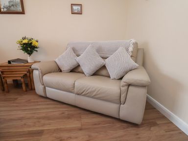 A sofa with cushions and a coffee table in a living room at La Rochelle in Whitby