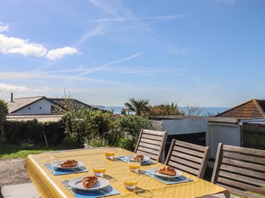 A table set with food and drinks in the garden at Highdown in Bigbury on Sea near Modbury