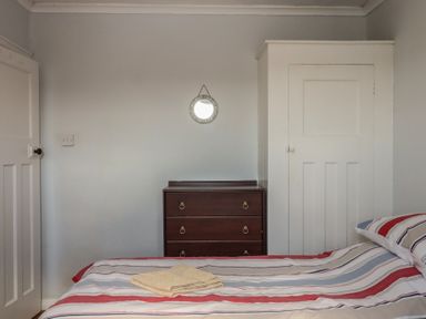 A bedroom with a bed and chest of drawers at Highdown Bigbury on Sea near Modbury