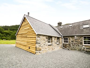A stone and wood house with slate roof and gravel ground at Hen Gelligemlyn - The Annexe in Ganllwyd