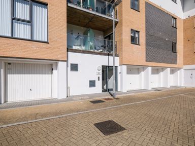 The exterior of a modern building with garages and balconies at Stone's Throw in Charlestown