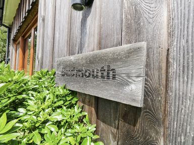 A sign reading Budmouth on a wooden wall at Budmouth Upwey near Weymouth