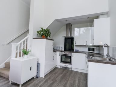 A kitchen with cabinets and appliances at Budmouth Upwey near Weymouth