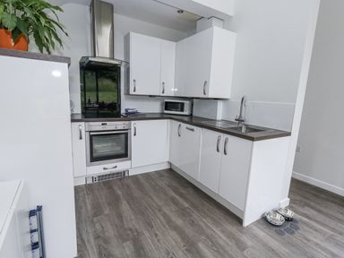 A kitchen with cabinets and appliances at Budmouth in Upwey near Weymouth