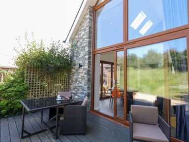An outdoor space with a table and chairs at Shepherd Oak in Upwey near Weymouth