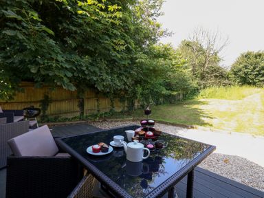 An outdoor table set with cupcakes and tea at Shepherd Oak in Upwey near Weymouth