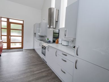 A kitchen with cabinets and appliances at Everdene Upwey near Weymouth