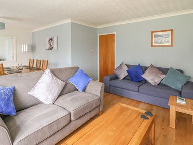 A living room with two sofas and a wooden coffee table at Trederwen in Rhayader