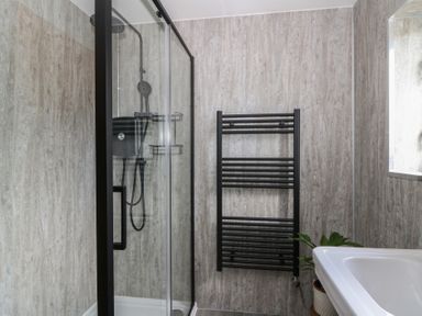 A bathroom with a shower and towel radiator at Red Kite Cottage Howey near Llandrindod Wells